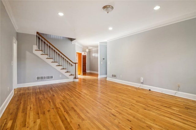 unfurnished living room with light wood-type flooring and crown molding