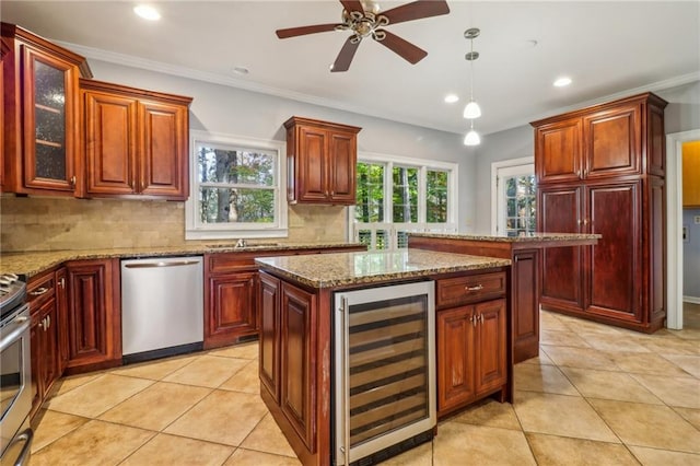 kitchen featuring crown molding, wine cooler, appliances with stainless steel finishes, tasteful backsplash, and a kitchen island