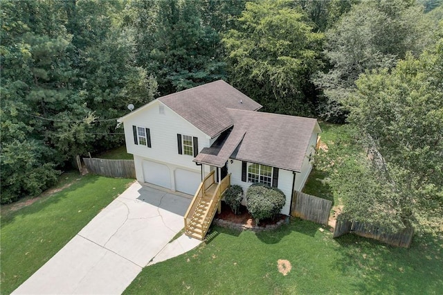 view of front of property featuring a garage and a front lawn