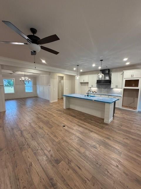 kitchen featuring light wood-type flooring, a ceiling fan, open floor plan, white cabinets, and recessed lighting