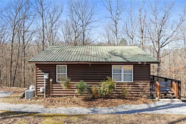 view of front of property with a wooden deck and central AC unit