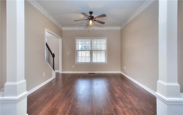 empty room featuring ceiling fan, crown molding, dark hardwood / wood-style floors, and ornate columns