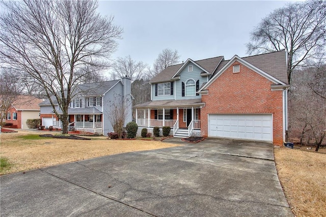 view of front facade featuring covered porch, a garage, and a front lawn