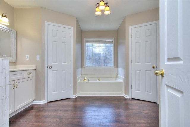 bathroom featuring hardwood / wood-style floors, a bathtub, and vanity