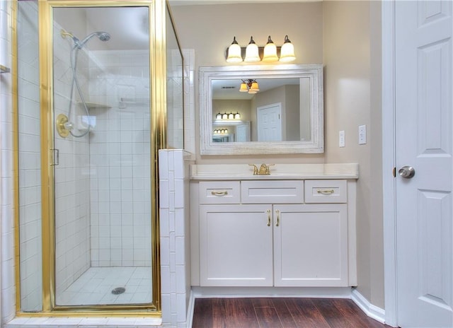 bathroom with vanity, hardwood / wood-style flooring, and walk in shower