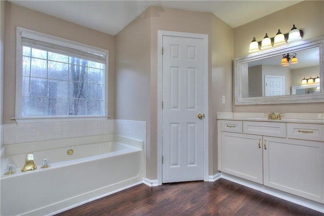 bathroom featuring a tub, hardwood / wood-style flooring, and vanity