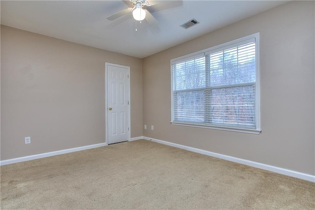 carpeted spare room with ceiling fan