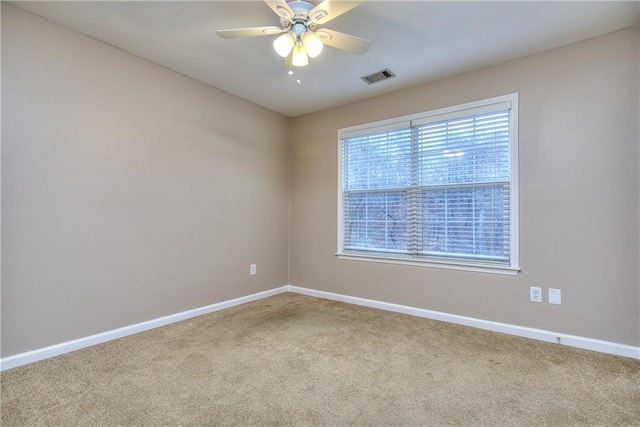 spare room featuring ceiling fan and carpet