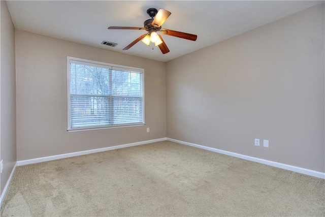 spare room with light carpet and ceiling fan