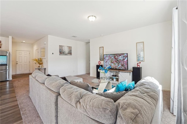 living area with wood finished floors and baseboards