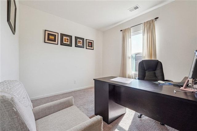 carpeted office space featuring baseboards and visible vents