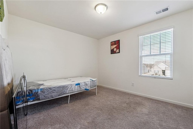 carpeted bedroom with visible vents and baseboards