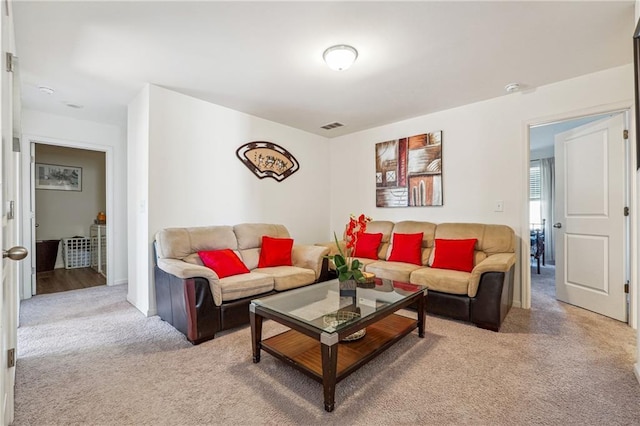 living room featuring light carpet and visible vents