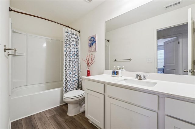 full bathroom featuring visible vents, shower / bathtub combination with curtain, toilet, vanity, and wood finished floors