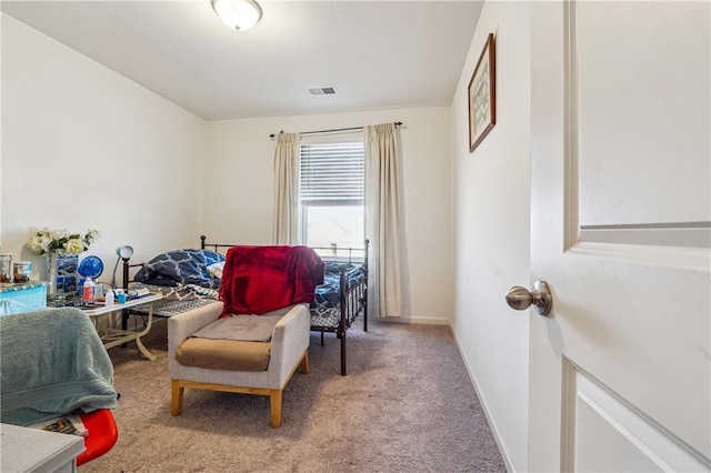 sitting room featuring carpet floors, visible vents, and baseboards