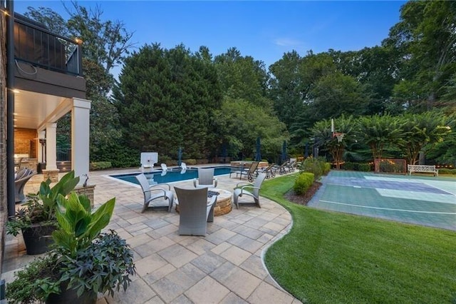 view of pool with a patio and a lawn