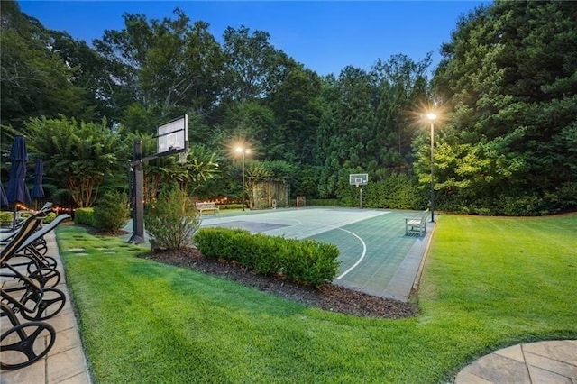 view of sport court with a yard