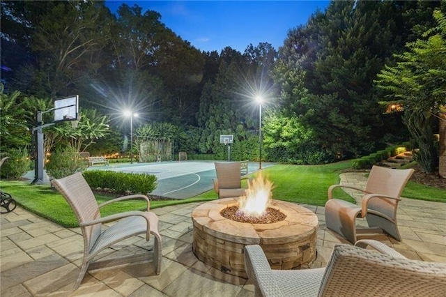 view of patio featuring basketball court and an outdoor fire pit