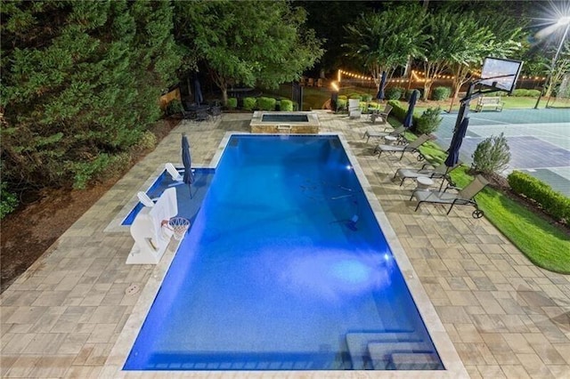 view of pool with a hot tub