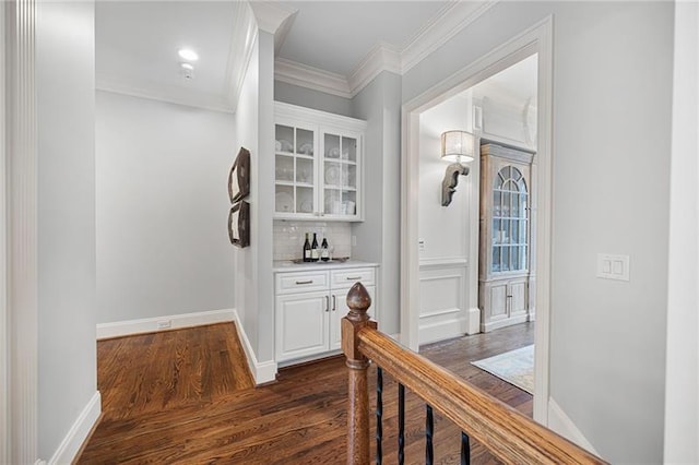 hall with dark hardwood / wood-style flooring and ornamental molding