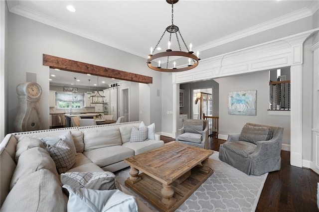 living room featuring ornamental molding, a notable chandelier, and dark hardwood / wood-style floors