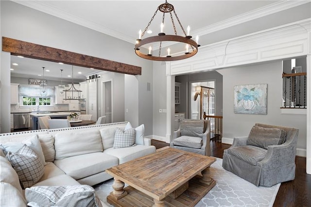 living room featuring hardwood / wood-style floors, an inviting chandelier, and crown molding