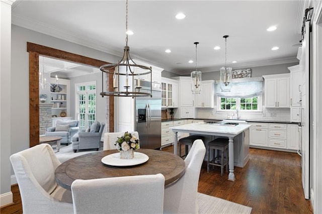 dining space with ornamental molding, dark wood-type flooring, and a wealth of natural light