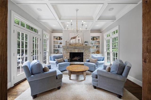 living room featuring french doors, coffered ceiling, and built in features