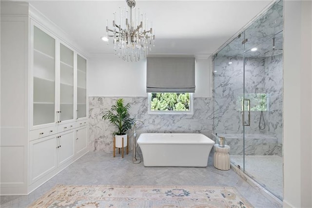 bathroom featuring an inviting chandelier and separate shower and tub