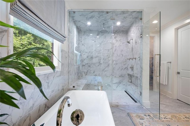 bathroom with separate shower and tub and plenty of natural light