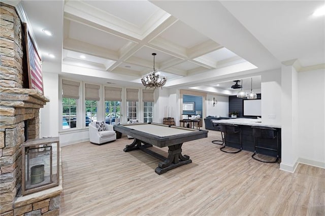 recreation room featuring beamed ceiling, french doors, billiards, light wood-type flooring, and a stone fireplace