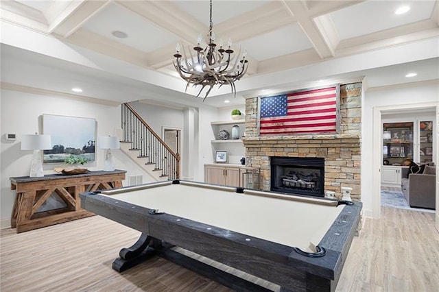 recreation room with billiards, light wood-type flooring, beam ceiling, a fireplace, and coffered ceiling