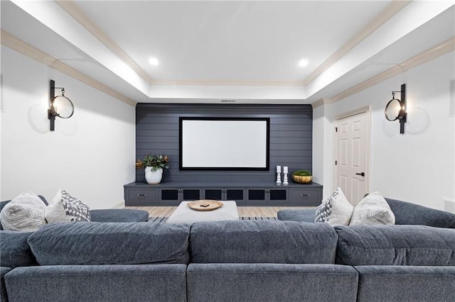 home theater featuring ornamental molding and a tray ceiling