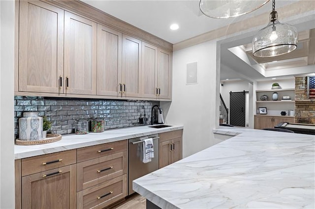 kitchen featuring light stone countertops, dishwasher, pendant lighting, tasteful backsplash, and sink