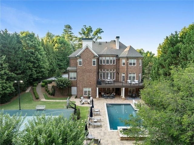 rear view of property featuring a patio area and a yard