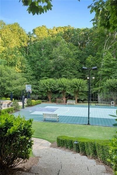 view of basketball court with a lawn