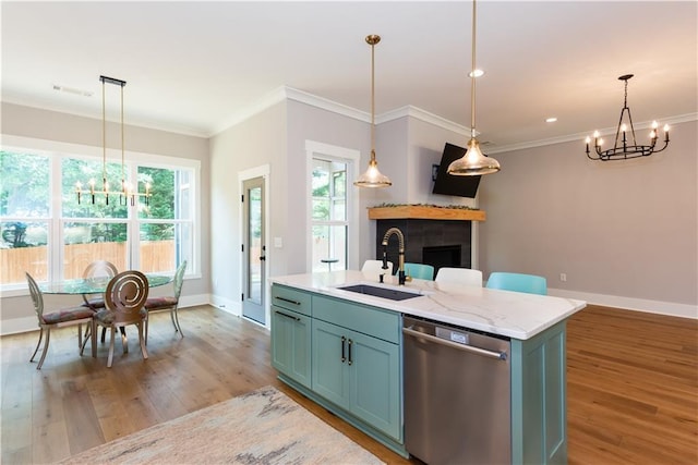 kitchen with stainless steel dishwasher, a chandelier, a sink, and light wood-style floors