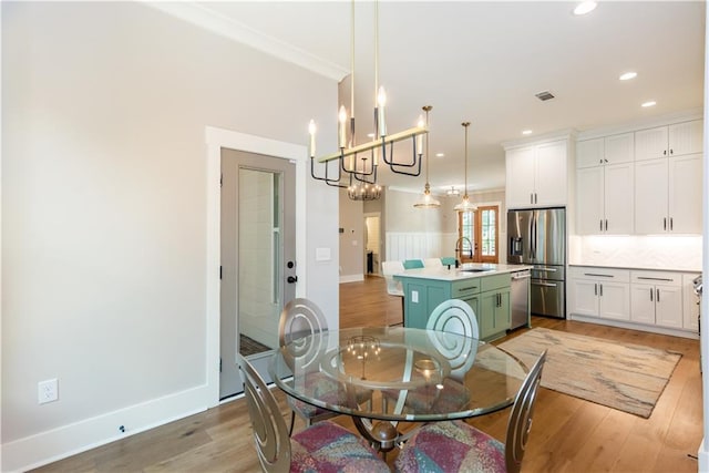 dining area featuring light wood-type flooring, recessed lighting, a notable chandelier, and visible vents