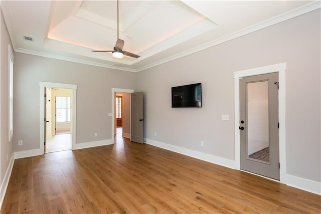 unfurnished living room featuring crown molding, a raised ceiling, a ceiling fan, and visible vents