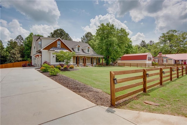 cape cod house with fence, covered porch, and a front yard
