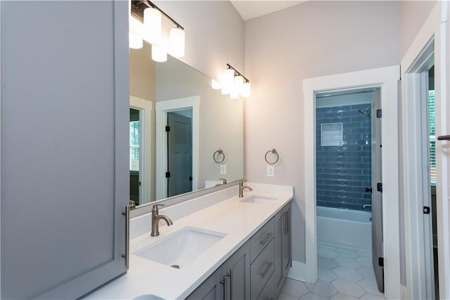full bath with a sink, tile patterned flooring, shower / bath combination, and double vanity