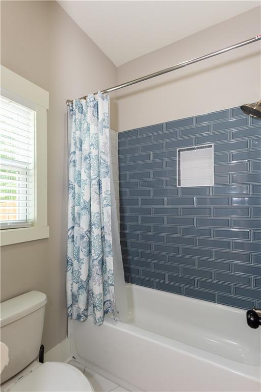 full bathroom featuring toilet and shower / tub combo