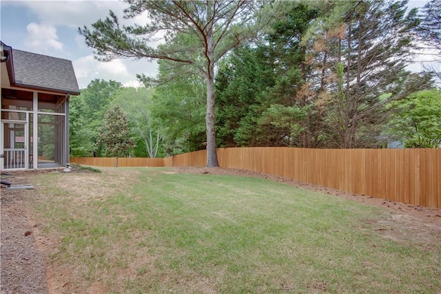 view of yard with a sunroom and fence