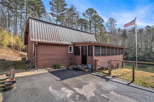 view of front of property featuring a sunroom