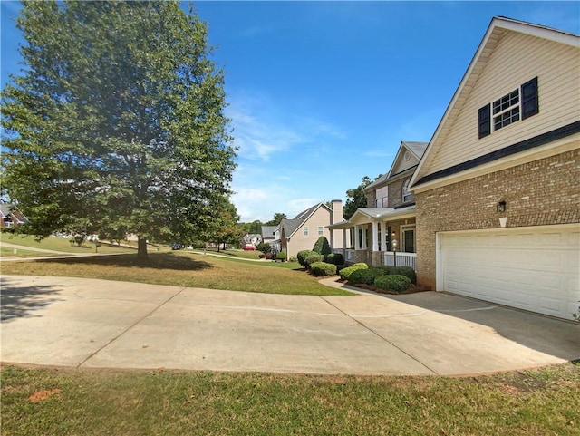 view of side of property with a lawn and a garage