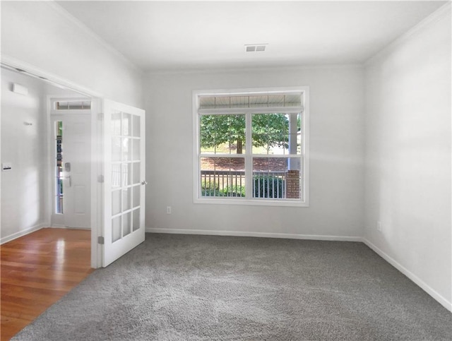 unfurnished room with carpet floors, french doors, and ornamental molding