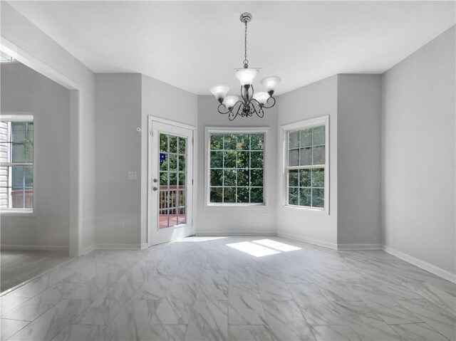 spare room featuring an inviting chandelier