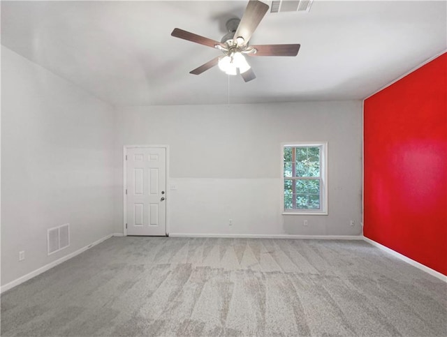 empty room with ceiling fan and light colored carpet