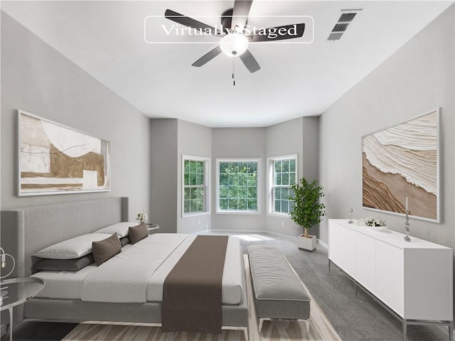 bedroom with dark colored carpet and ceiling fan