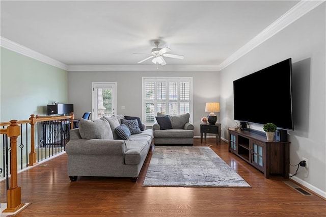 living room with crown molding, dark hardwood / wood-style floors, and ceiling fan